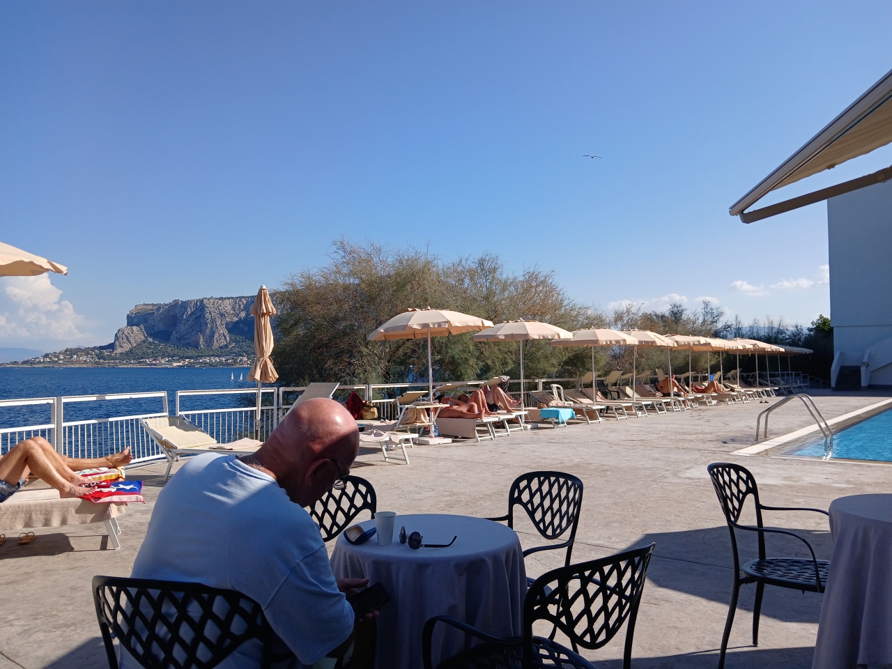 Swimming pool beside the sea showing two different swimming environments