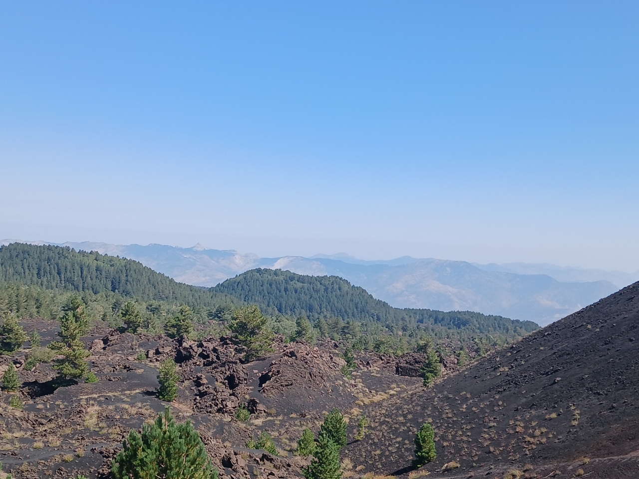 View across the volcanic slopes and mountains from Mount Etna